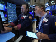 FILE - Specialist Michael Pistillo, left, and trader Robert Charmak work on the floor of the New York Stock Exchange, May 30, 2024. World shares began June mostly higher after a report showing that inflation in the U.S. is not worsening drove a rally on Wall Street.