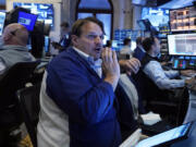 FILE - Trader Michael Milano, center, works with colleagues on the floor of the New York Stock Exchange on May 30, 2024. World stocks are mixed on Friday, June 7, 2024, after a steady day on Wall Street as markets anticipate key U.S. jobs data to be revealed later in the day.