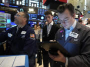 FILE - Trader William Lovesick, right works on the floor of the New York Stock Exchange, June 12, 2024. Shares have opened mixed in Europe on Monday, June 17, 2024, as markets recovered from shocks of recent elections across the region.