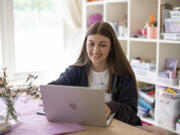 Amea Wadsworth works on her computer April 19 at her home in San Diego. Wadsworth, who moved back home after graduating college, wanted to use her first full-time job as a chance to save, and a moment to take a hard look at her spending activity.