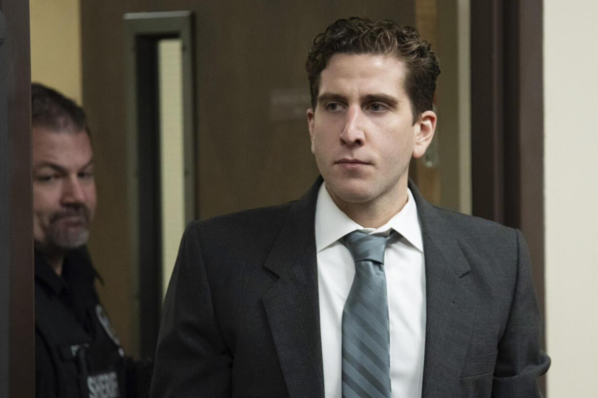 FILE - Bryan Kohberger, right, is escorted into a courtroom for a hearing in Latah County District Court, Sept. 13, 2023, in Moscow, Idaho. Attorneys for Kohberger, the man charged with stabbing four University of Idaho students to death, are expected to ask a judge to move the trial away from the rural college town where the slayings occurred. (AP Photo/Ted S.