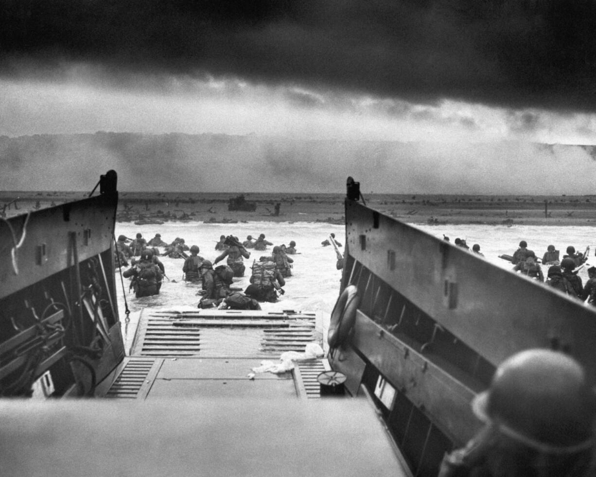 FILE - This photograph is believed to show E Company, 16th Regiment, 1st Infantry Division, participating in the first wave of assaults during D-Day in Normandy, France, June 6, 1944. The greatest armada ever assembled, nearly 7,000 ships and boats, supported by more than 11,000 planes, carried almost 133,000 troops across the Channel to establish toeholds on five heavily defended beaches stretched across 80 kilometers (50 miles) of Normandy coast. More than 9,000 Allied soldiers were killed or wounded in the first 24 hours. (Chief Photographer&#039;s Mate Robert M. Sargent, U.S.