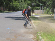 Antonio Espinoza, a supervisor with the Gras Lawn landscaping company, uses a gasoline-powered leaf blower to clean up around a housing development Tuesday in Brick, N.J. New Jersey is one of many states either considering or already having banned gasoline-powered leaf blowers on environmental and health grounds.