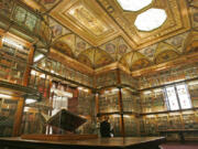 A 1455 Biblia Latina by Johannes Gutenberg and Johann Fust, foreground left, is on display inside the personal library of Pierpont Morgan, at the Morgan Library and Museum in New York. Three times per year, a library curator turns the page.