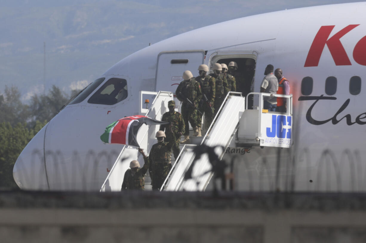 Police from Kenya deplane at the Toussaint Louverture International Airport in Port-au-Prince, Haiti, Tuesday, June 25, 2024. The first U.N.-backed contingent of foreign police arrived nearly two years after the Caribbean country requested help to quell a surge in gang violence.