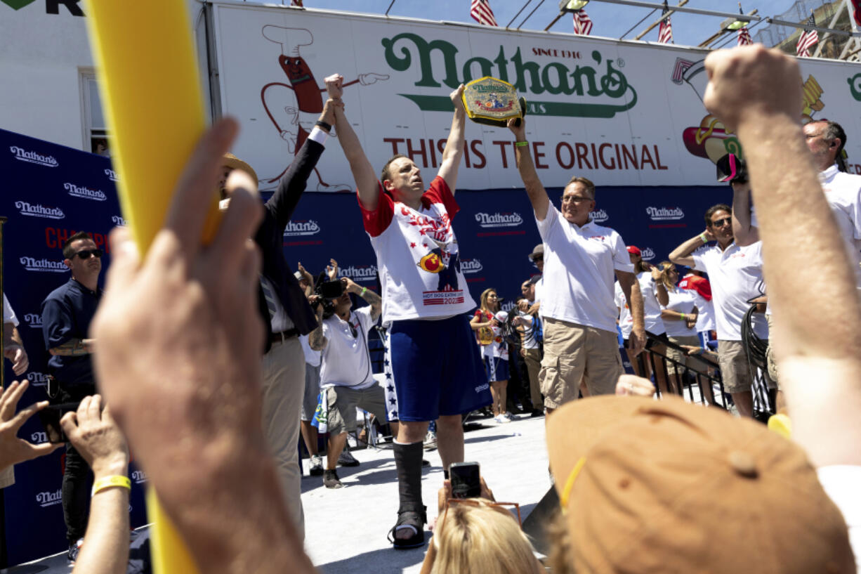 FILE - Joey Chestnut, center left, celebrates winning the Nathan&rsquo;s Famous Fourth of July hot dog eating contest in Coney Island on July 4, 2022, in New York. Organizers announced on Tuesday, June 11, 2024, that Chestnut won&rsquo;t compete in this year&rsquo;s competition due to a contract dispute.