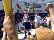 FILE - Joey Chestnut, center left, celebrates winning the Nathan&rsquo;s Famous Fourth of July hot dog eating contest in Coney Island on July 4, 2022, in New York. Organizers announced on Tuesday, June 11, 2024, that Chestnut won&rsquo;t compete in this year&rsquo;s competition due to a contract dispute.