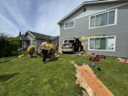 Longview fire personnel extract a woman trapped in an apartment after a minivan crashed through the wall.