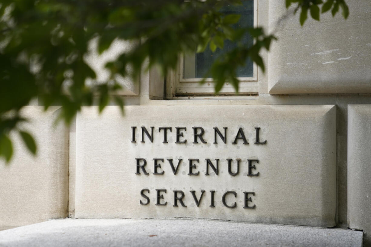 FILE - A sign outside the Internal Revenue Service building is seen, May 4, 2021, in Washington. The government is making permanent its new free electronic tax return filing system and expanding to taxpayers in all 50 states.