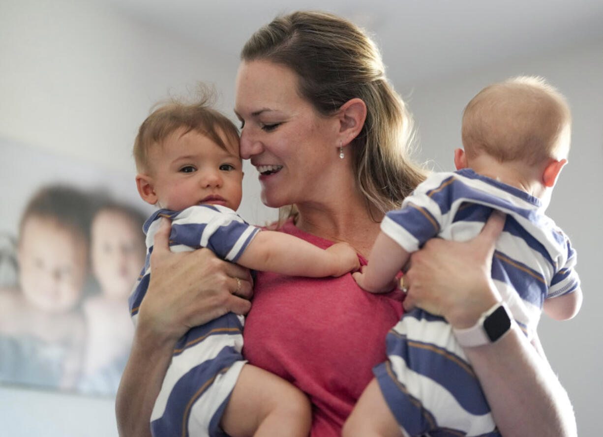 Amanda Visser holds her embryo-adopted six-month-old sons Collin and Jackson at her home May 13, in Sterling, Colo. When faced with infertility, Christians who believe life begins at or around conception wrestle with the ethics of IVF and how to build a family in a way that conforms with their beliefs.