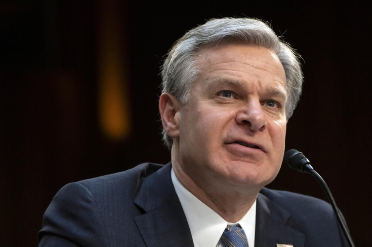 FBI Director Christopher Wray speaks during a hearing of the Senate Intelligence Committee on Capitol Hill, March 11, 2024, in Washington. Eight individuals from Tajikistan with suspected ties to the Islamic State have been arrested in the United States in recent days.