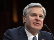 FBI Director Christopher Wray speaks during a hearing of the Senate Intelligence Committee on Capitol Hill, March 11, 2024, in Washington. Eight individuals from Tajikistan with suspected ties to the Islamic State have been arrested in the United States in recent days.