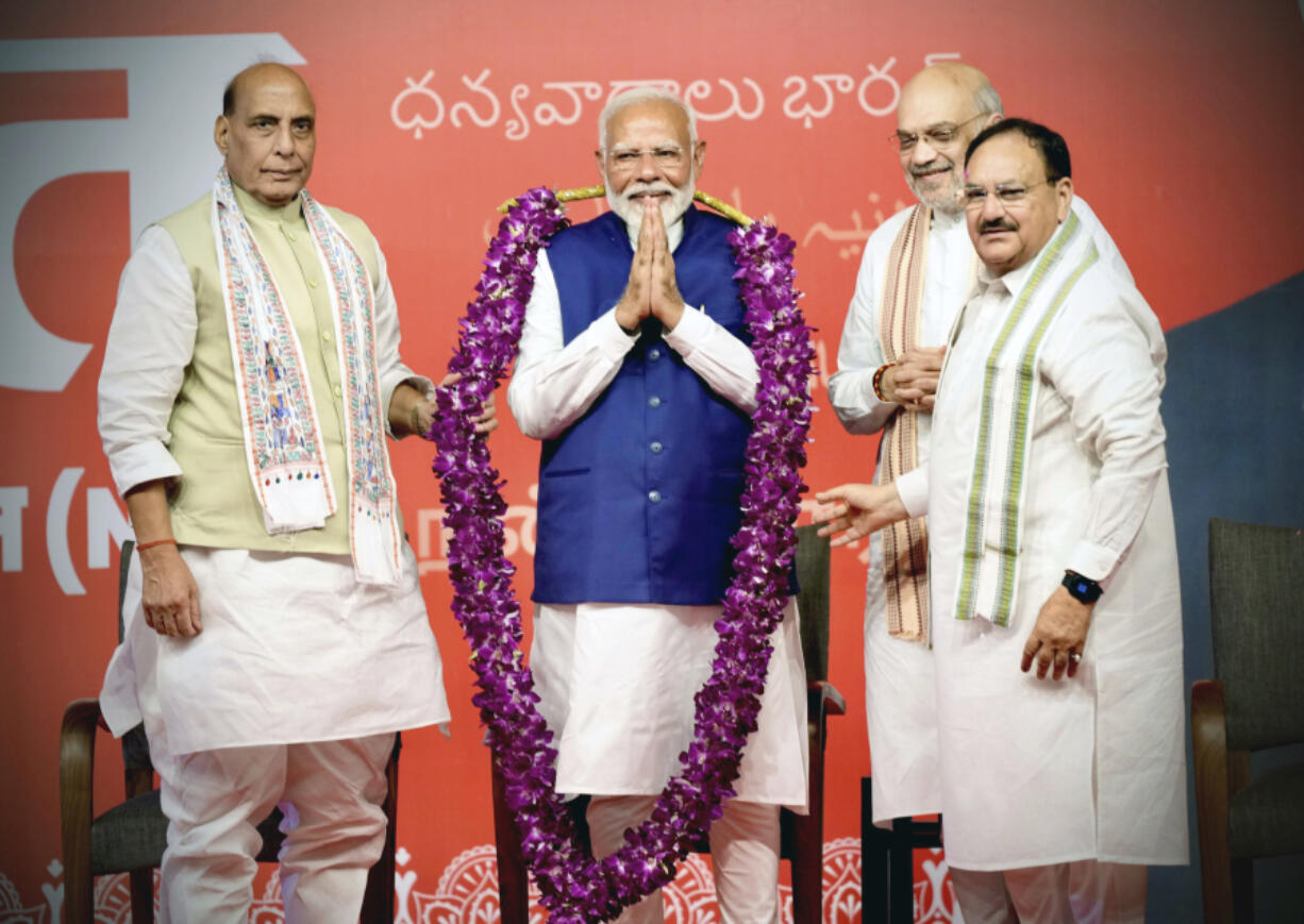 Prime Minister Narendra Modi is garlanded by senior Bharatiya Janata Party (BJP) leaders Rajnath Singh, left, party President JP Nadda, right, and Amit Shah, at the party headquarters in New Delhi, India, Tuesday, June 4, 2024.