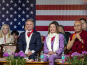 Republican Rep. Michael McCaul, left, and Democratic former House Speaker Nancy Pelosi sit in the front row with Khenpo Sonam Tenphel, Speaker of the Tibetan parliament-in-exile, at a public event during which they were felicitated by the President of the Central Tibetan Administration and other officials at the Tsuglakhang temple in Dharamshala, India, Wednesday, June 19, 2024.