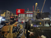 Iraqi security forces stand guard in front of Kentucky Fried Chicken restaurant in Baghdad, Wednesday, June 5, 2024. The recent protests &mdash; apparently organised by supporters of Iran-backed, anti-American militias in Iraq &mdash; reflect surging anger against the United States, Israel&rsquo;s top ally, over the war in Gaza.