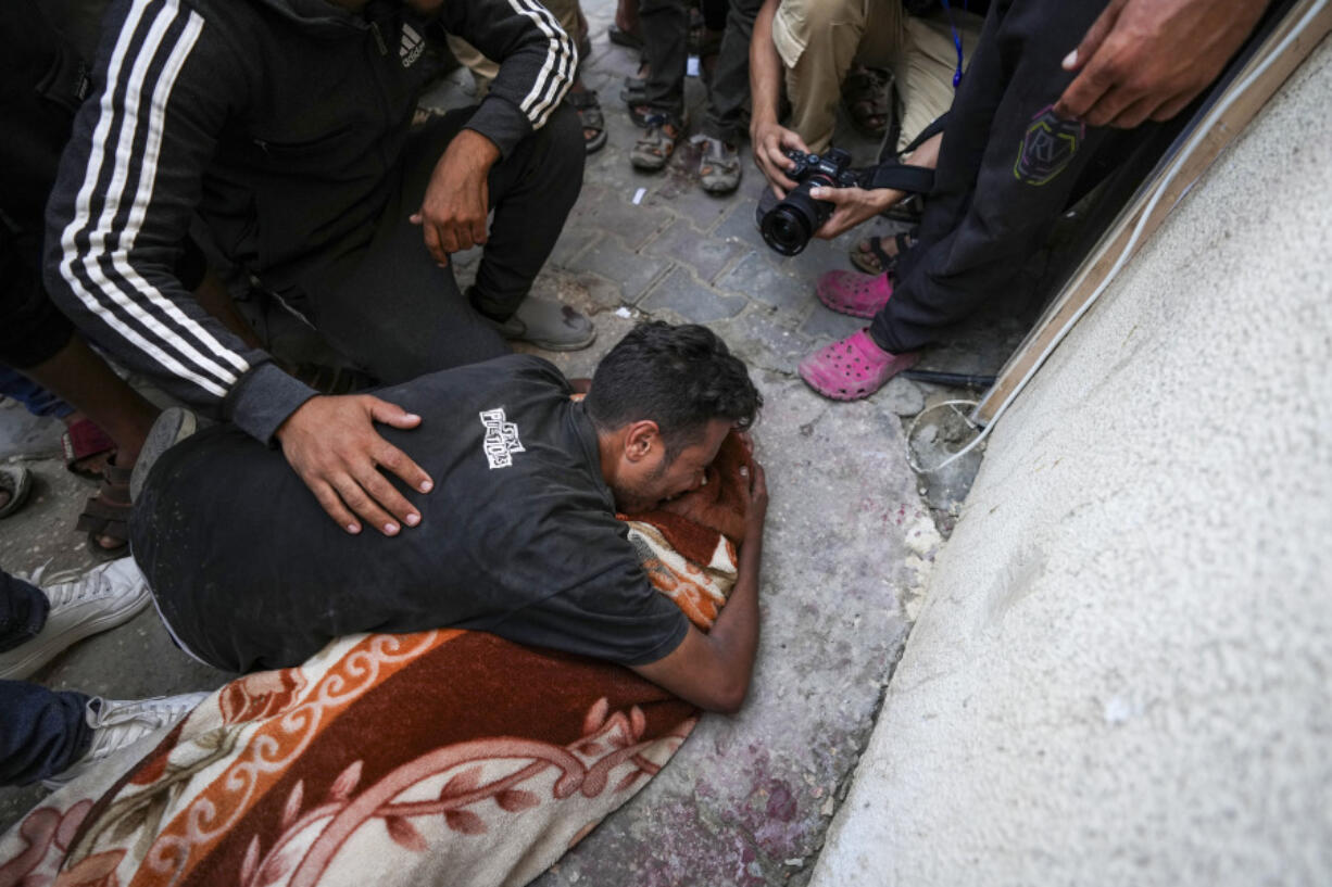 A Palestinian mourns a relative killed in an Israeli bombardment on Tuesday outside a hospital in Deir al Balah, Gaza Strip.