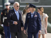 President Joe Biden is escorted by Air Force Col. Angela Ochoa, Commander, 89th Airlift Wing, as he arrives at Andrews Air Force Base, Md., Wednesday, June 12, 2024. Biden is headed to Italy for the G7 summit. Biden&rsquo;s granddaughter, Finnegan Biden, walks right.