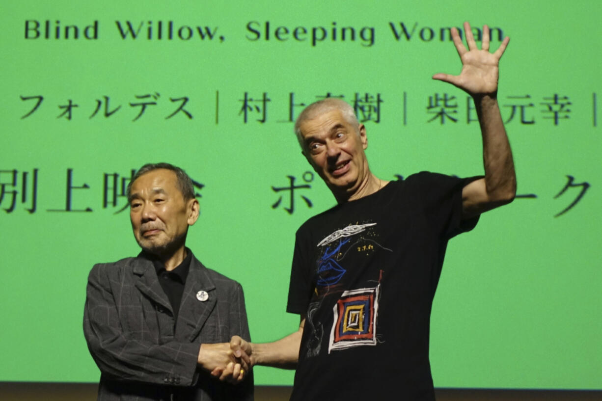 Novelist Haruki Murakami and film director Pierre Foldes shake hands at the end of a talk session June 15 after a screening of &ldquo;Blind Willow, Sleeping Woman,&rdquo; an animated film adapted from the Japanese author&rsquo;s short stories, in Tokyo.