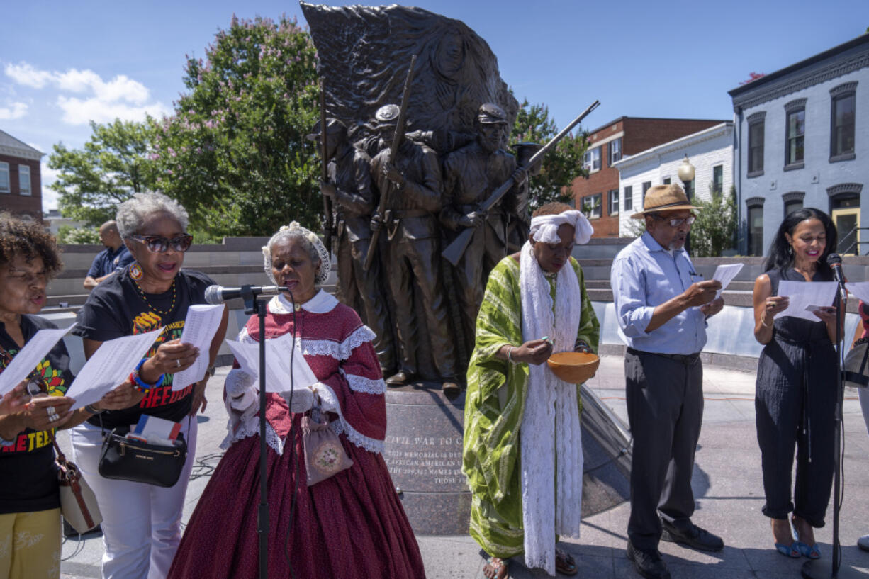 Participants read the names of United States Colored Troops at the African American Civil War Memorial as part of Juneteenth commemorations on Wednesday, June 19, 2024, in Washington.