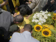 Mourners kiss the coffin of Hezbollah senior commander Taleb Sami Abdullah, 55, known within Hezbollah as Hajj Abu Taleb, who was killed late Tuesday by an Israeli strike in south Lebanon, during his funeral procession in the southern suburbs of Beirut, Lebanon, Wednesday, June 12, 2024. Hezbollah fired a massive barrage of rockets into northern Israel on Wednesday to avenge the killing of the top commander in the Lebanese militant group as the fate of an internationally-backed plan for a cease-fire in Gaza hung in the balance.