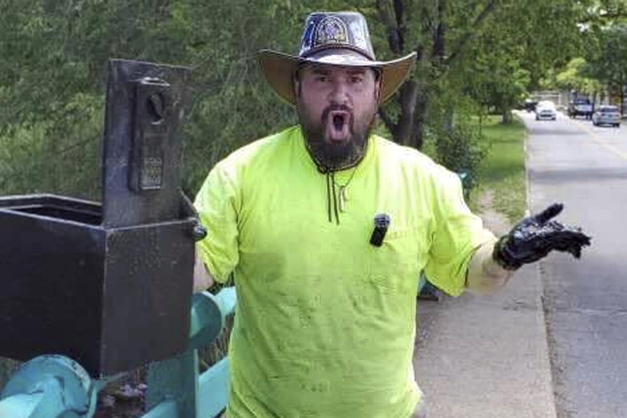 Magnet fisher James Kane exclaims as he reacts May 31 to the contents of a safe he pulled out of a pond, in Flushing Meadows Corona Park, in the Queens borough of New York.