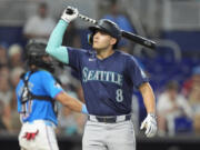 Seattle Mariners&#039; Dominic Canzone (8) reacts after he struck out swinging during the sixth inning of a baseball game against the Miami Marlins, Sunday, June 23, 2024, in Miami.