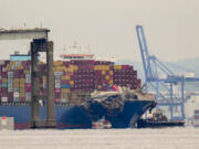 Tugboats escort the cargo ship Dali after it was refloated in Baltimore, Monday, May 20, 2024. The vessel struck the Francis Scott Key Bridge on March 26 causing it to collapse and resulting in the death of six people.