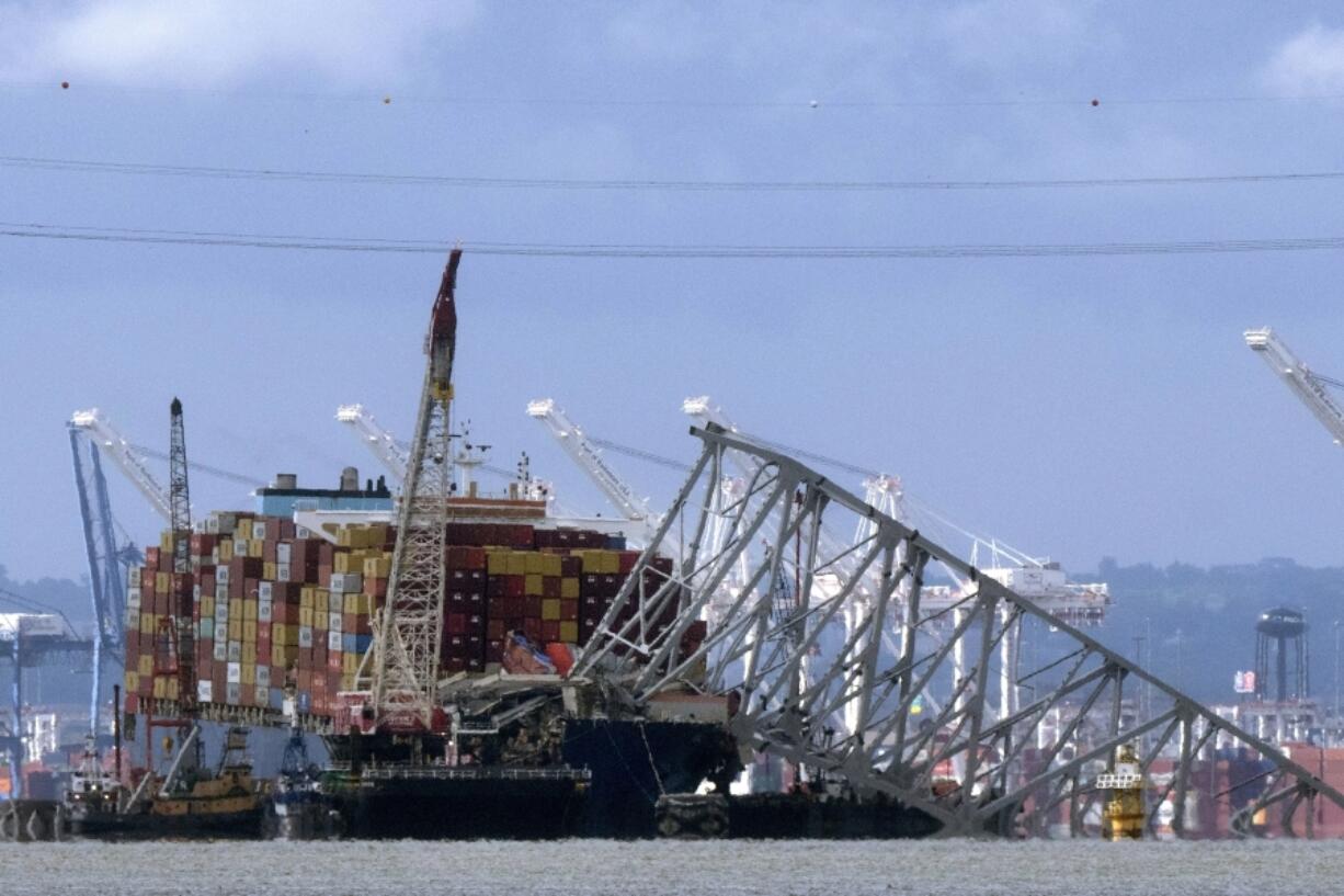 FILE - The collapsed Francis Scott Key Bridge rests on the container ship Dali, May 12, 2024, in Baltimore, as seen from Riviera Beach, Md. Crew members on the cargo ship Dali can head home as soon as Thursday, June 20, 2024, under an agreement that allows lawyers to question them amid ongoing investigations into what led to the deadly collapse of Baltimore&rsquo;s Francis Scott Key Bridge.