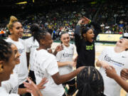 Seattle Storm players, including center Mercedes Russell, third from left, guard Jewell Loyd, guard Nika Muhl, guard Jordan Horston and guard Sami Whitcomb, right, laugh as they huddle before facing the Phoenix Mercury in a WNBA basketball game Tuesday, June 4, 2024, in Seattle.