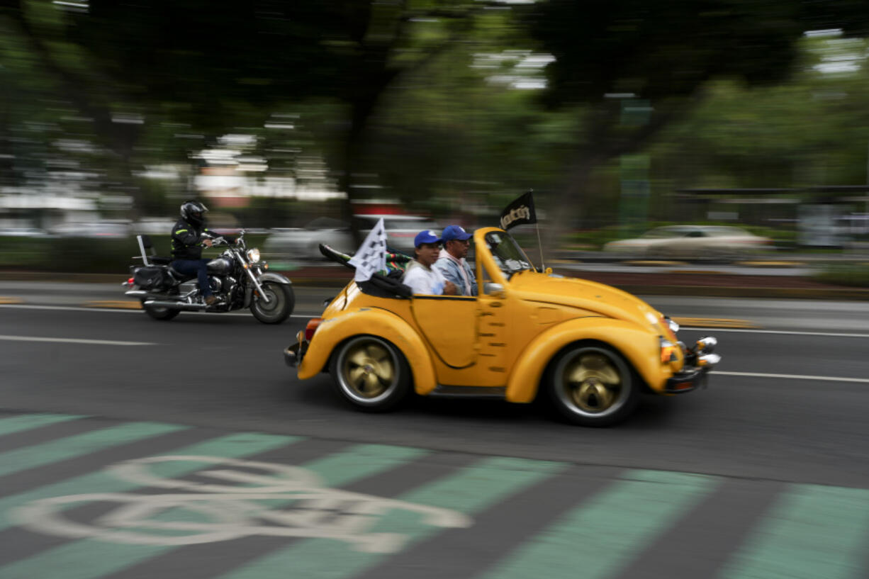 An antique Volkswagen Beetle, known in Mexico as a &ldquo;vocho,&rdquo; parades through the streets a day after World Vocho Day, in Mexico City, Sunday, June 23, 2024.