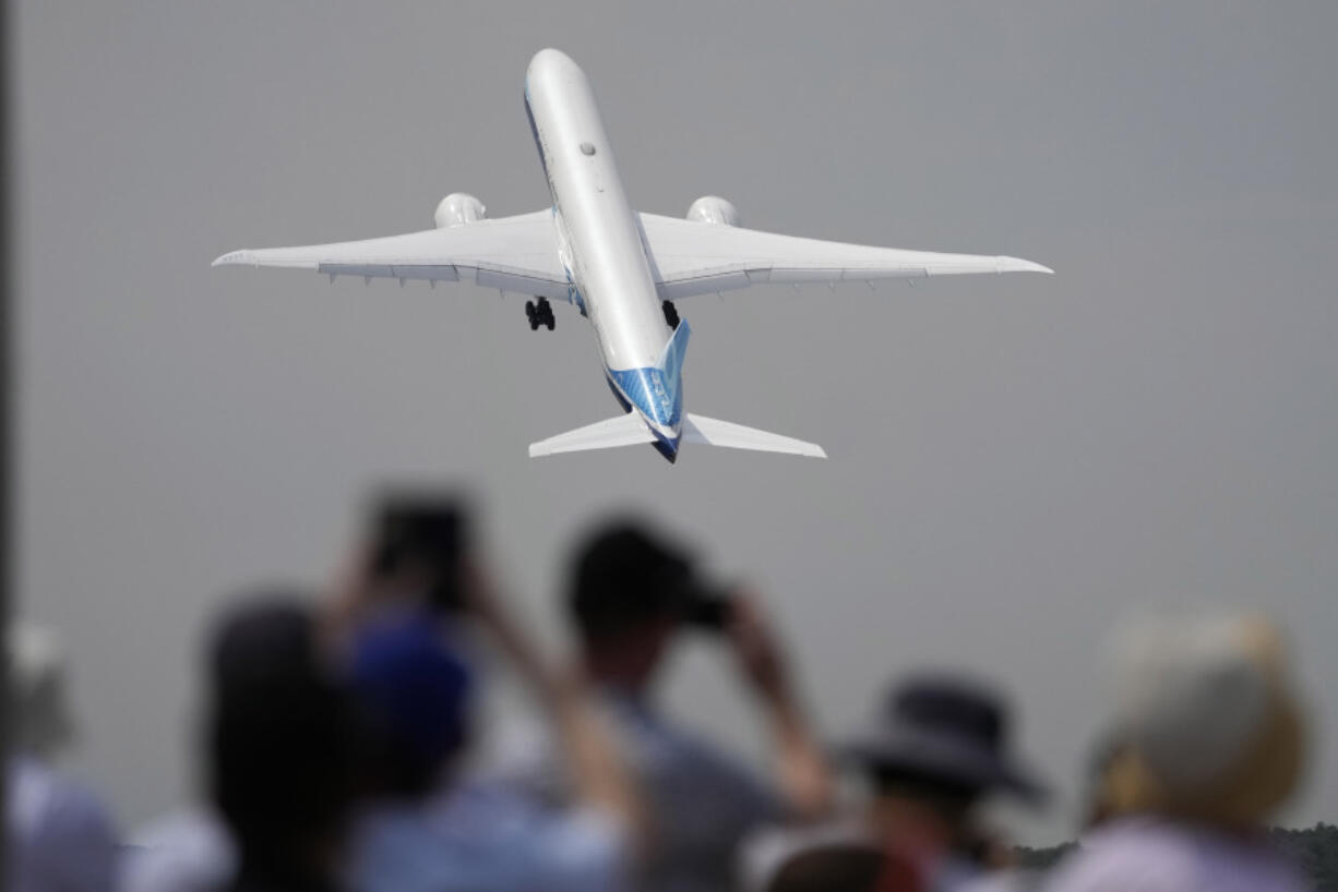 FILE - A Boeing 777X plane takes off at the Farnborough Air Show fair in Farnborough, England, on July 18, 2022. The cost of your next flight is likely to go up. That&rsquo;s the word from the International Air Transport Association, which held its annual meeting Monday June 3, 2024 in Dubai, home to the long-haul carrier Emirates.