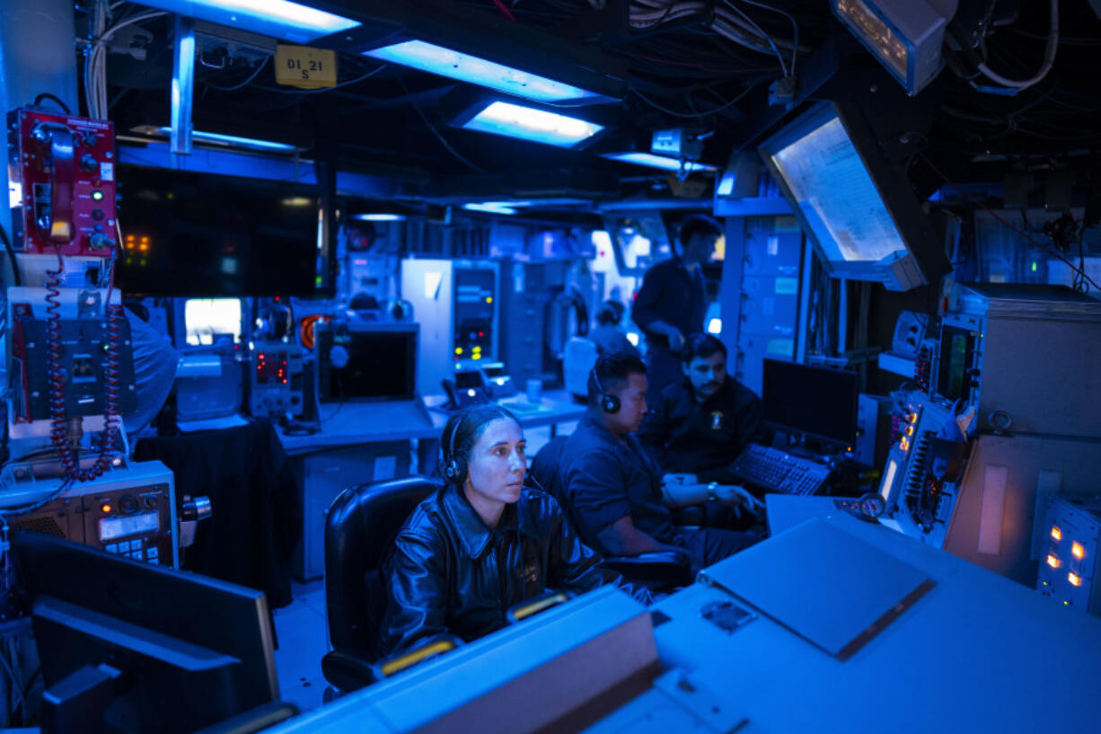 Crew members work in the combat information center of the Arleigh Burke-class guided missile destroyer USS Laboon during a deployment in the Red Sea on Wednesday, June 12, 2024. The U.S.-led campaign against Iran-backed Houthi rebels has turned into the most intense running sea battle the Navy has faced since World War II. That&rsquo;s what its leaders and experts tell The Associated Press, whose journalists visited U.S. ships off Yemen in recent days.