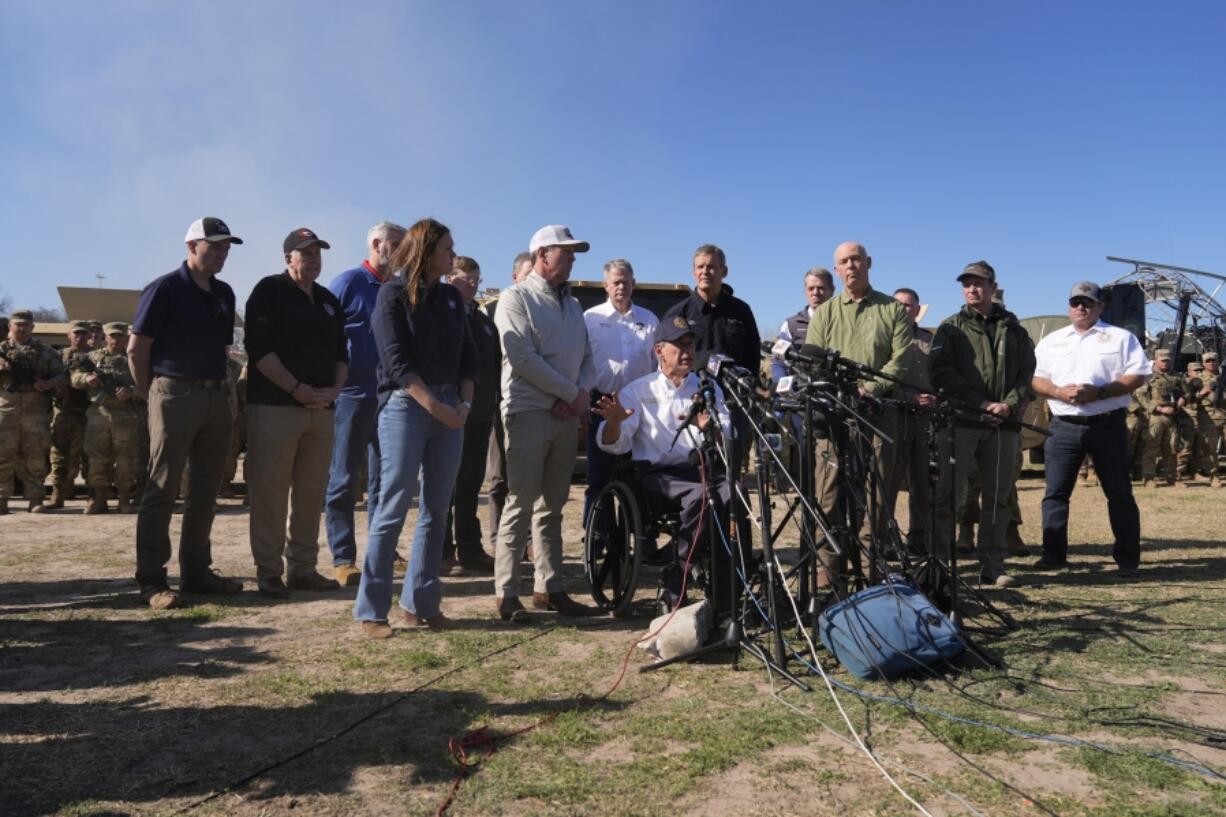 FILE - Texas Gov. Greg Abbott, center, is joined by fellow governors during a news conference along the Rio Grande to discuss Operation Lone Star and border concerns, Sunday, Feb. 4, 2024, in Eagle Pass, Texas. Louisiana lawmakers approved a bill Wednesday that would empower state and local law enforcement to arrest and jail people in the state who entered the U.S.