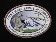 FILE - The logo of Joint Base Lewis-McChord is seen at a ceremony marking the merger of Fort Lewis and McChord Air Force Base into Joint Base Lewis-McChord, Feb. 1, 2010, in Washington state. Fifteen current or retired Joint Base Lewis-McChord servicemen who say the Army failed to protect them from a military doctor who&#039;s been charged with sexual abuse are seeking $5 million in damages for the emotional distress they say they&#039;ve suffered.  (AP Photo/Ted S.