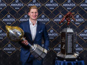 Colorado Avalanche forward Nathan MacKinnon stands with his trophies as the recipient of the Hart Memorial Trophy, left, and Ted Lindsay Award at hockey&rsquo;s NHL Awards, Thursday, June 27, 2024, in Las Vegas. (AP Photo/L.E.