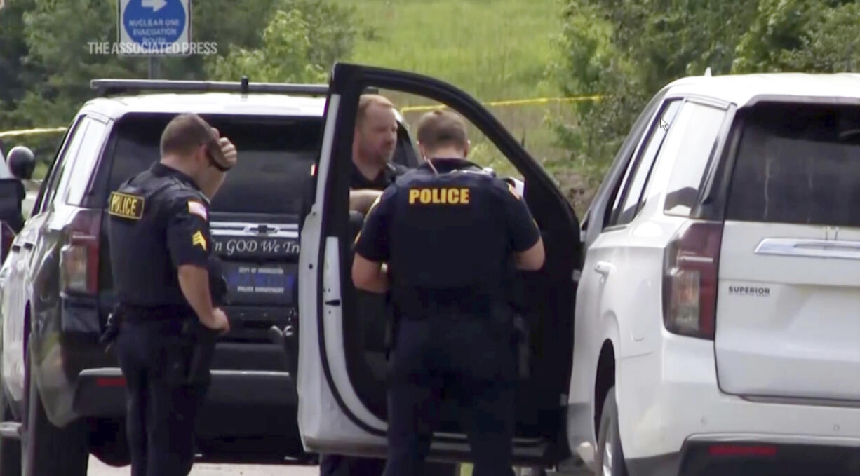 This image from video provided by KATV shows police officers at the scene where Stacy Lee Drake was taken into custody Thursday, June 20, 2024 in Morrilton, Ark. An Alabama man wanted in connection with homicides in Oklahoma and Alabama was apprehended Thursday in Arkansas after a search that spanned multiple southern states, Arkansas State Police said.