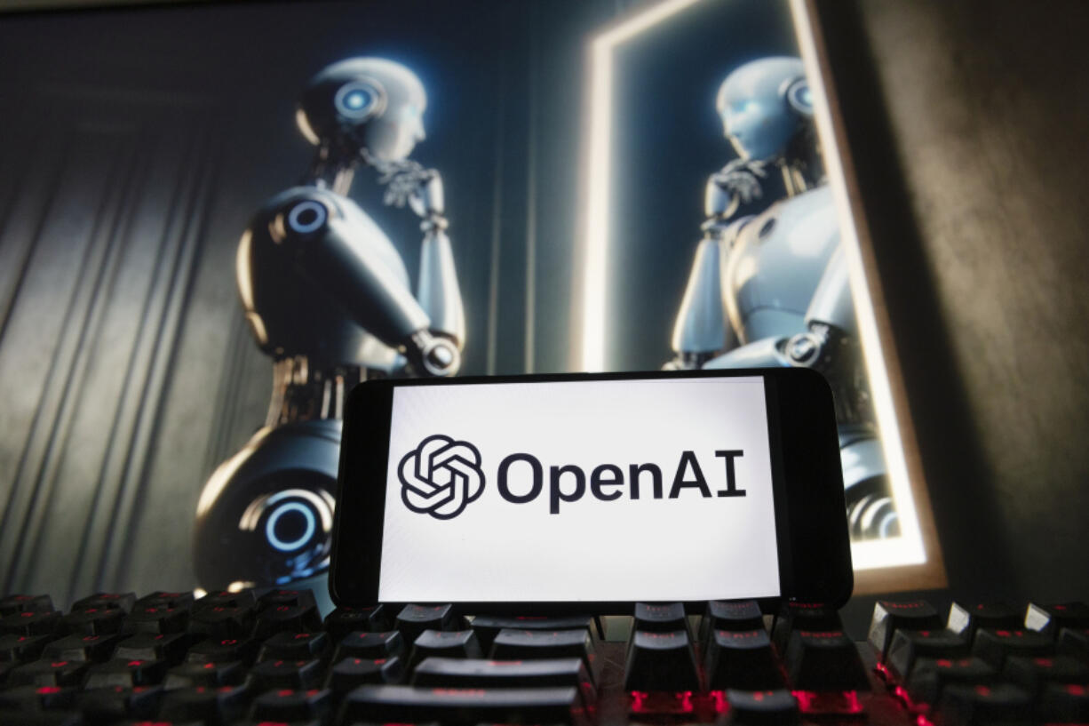 FILE- The OpenAI logo is displayed on a cell phone with an image on a computer monitor generated by ChatGPT&rsquo;s Dall-E text-to-image model, Dec. 8, 2023, in Boston. lya Sutskever, one of the founders of OpenAI who was involved in a failed effort to push out CEO Sam Altman, said he&rsquo;s starting a safety-focused artificial intelligence company. Sutskever, a respected AI researcher who left the ChatGPT maker last month, said in a social media post on Wednesday, June 19, 2024 that he&rsquo;s setting up Safe Superintelligence Inc. with two co-founders.