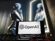 FILE- The OpenAI logo is displayed on a cell phone with an image on a computer monitor generated by ChatGPT&rsquo;s Dall-E text-to-image model, Dec. 8, 2023, in Boston. lya Sutskever, one of the founders of OpenAI who was involved in a failed effort to push out CEO Sam Altman, said he&rsquo;s starting a safety-focused artificial intelligence company. Sutskever, a respected AI researcher who left the ChatGPT maker last month, said in a social media post on Wednesday, June 19, 2024 that he&rsquo;s setting up Safe Superintelligence Inc. with two co-founders.