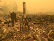 FILE - Chairs stand at the Gates Post office in the aftermath of a fire in Gates, Ore., Sept 9, 2020. The post office was destroyed along with several other buildings in the Santiam Canyon community as a result of the Santiam Fire. Pacific Power, owned by PacifiCorp, said Monday, June 3, 2024, that it has agreed to a nearly $180 million settlement with over 400 Oregon plaintiffs who sued the utility after the deadly 2020 wildfires.