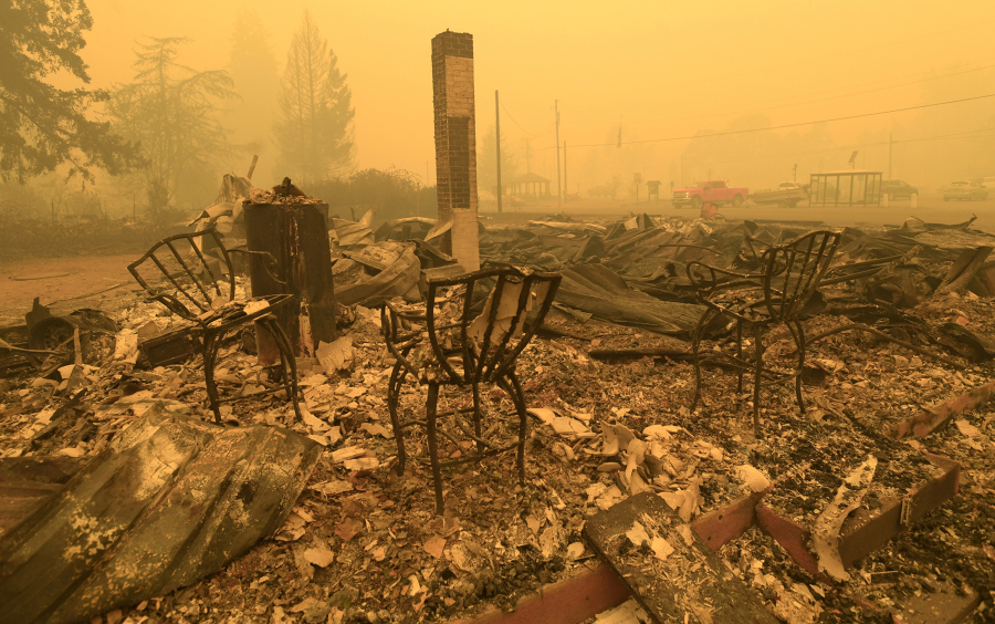 FILE - Chairs stand at the Gates Post office in the aftermath of a fire in Gates, Ore., Sept 9, 2020. The post office was destroyed along with several other buildings in the Santiam Canyon community as a result of the Santiam Fire. Pacific Power, owned by PacifiCorp, said Monday, June 3, 2024, that it has agreed to a nearly $180 million settlement with over 400 Oregon plaintiffs who sued the utility after the deadly 2020 wildfires.