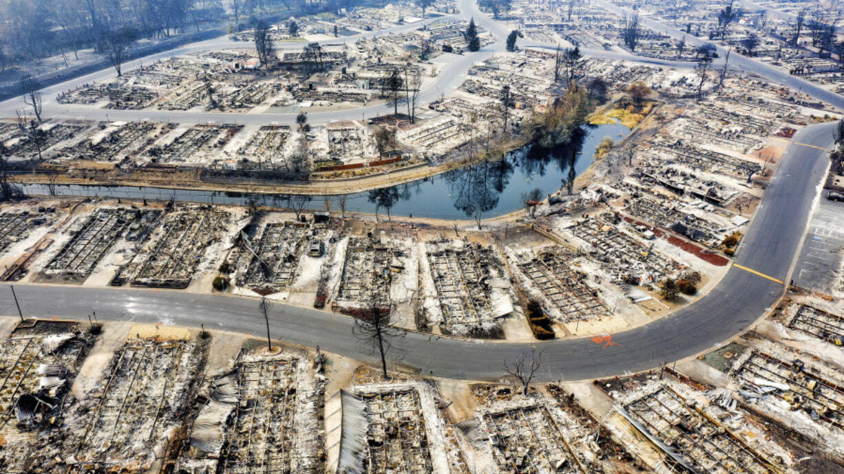 FILE - Homes leveled by the Almeda Fire are seen at Bear Lake Estates in Phoenix, Ore., on Sept. 15, 2020. Pacific Power, owned by PacifiCorp, said Monday, June 3, 2024, that it has agreed to a nearly $180 million settlement with over 400 Oregon plaintiffs who sued the utility after the deadly 2020 wildfires.