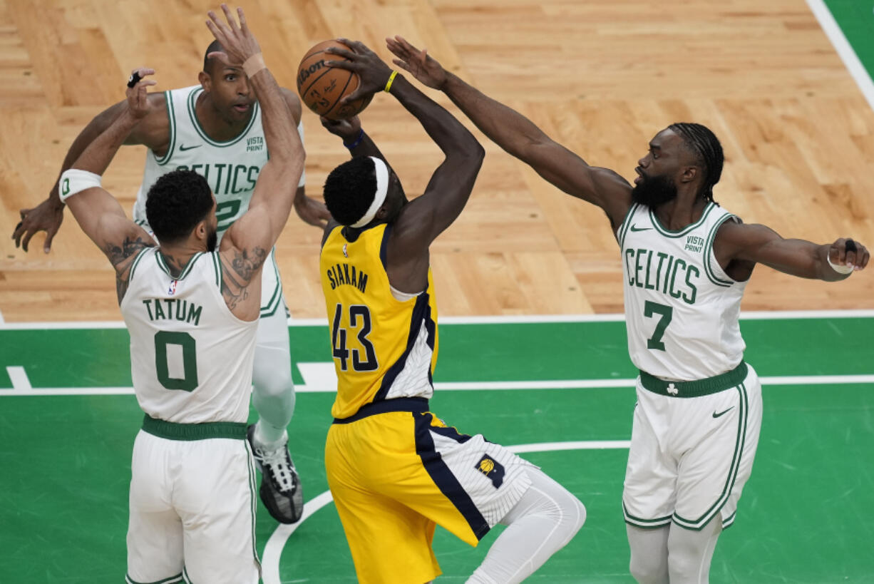 Indiana Pacers forward Pascal Siakam (43) goes up for a shot against Boston Celtics guard Jaylen Brown (7), forward Jayson Tatum (0) and center Al Horford (42) during the first quarter of Game 1 of the NBA Eastern Conference basketball finals, Tuesday, May 21, 2024, in Boston.