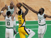 Indiana Pacers forward Pascal Siakam (43) goes up for a shot against Boston Celtics guard Jaylen Brown (7), forward Jayson Tatum (0) and center Al Horford (42) during the first quarter of Game 1 of the NBA Eastern Conference basketball finals, Tuesday, May 21, 2024, in Boston.