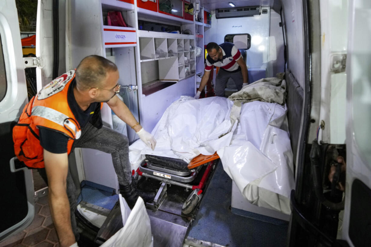 Palestinian medics move five bodies including the body of Iyadd al-maghari, the mayor of Nusseirat refugee camp, killed in the Israeli bombardment of the Gaza Strip, to the morgue of al-Aqsa Martyrs hospital in Deir al-Balah, central Gaza Strip, late Thursday, June 6, 2024.