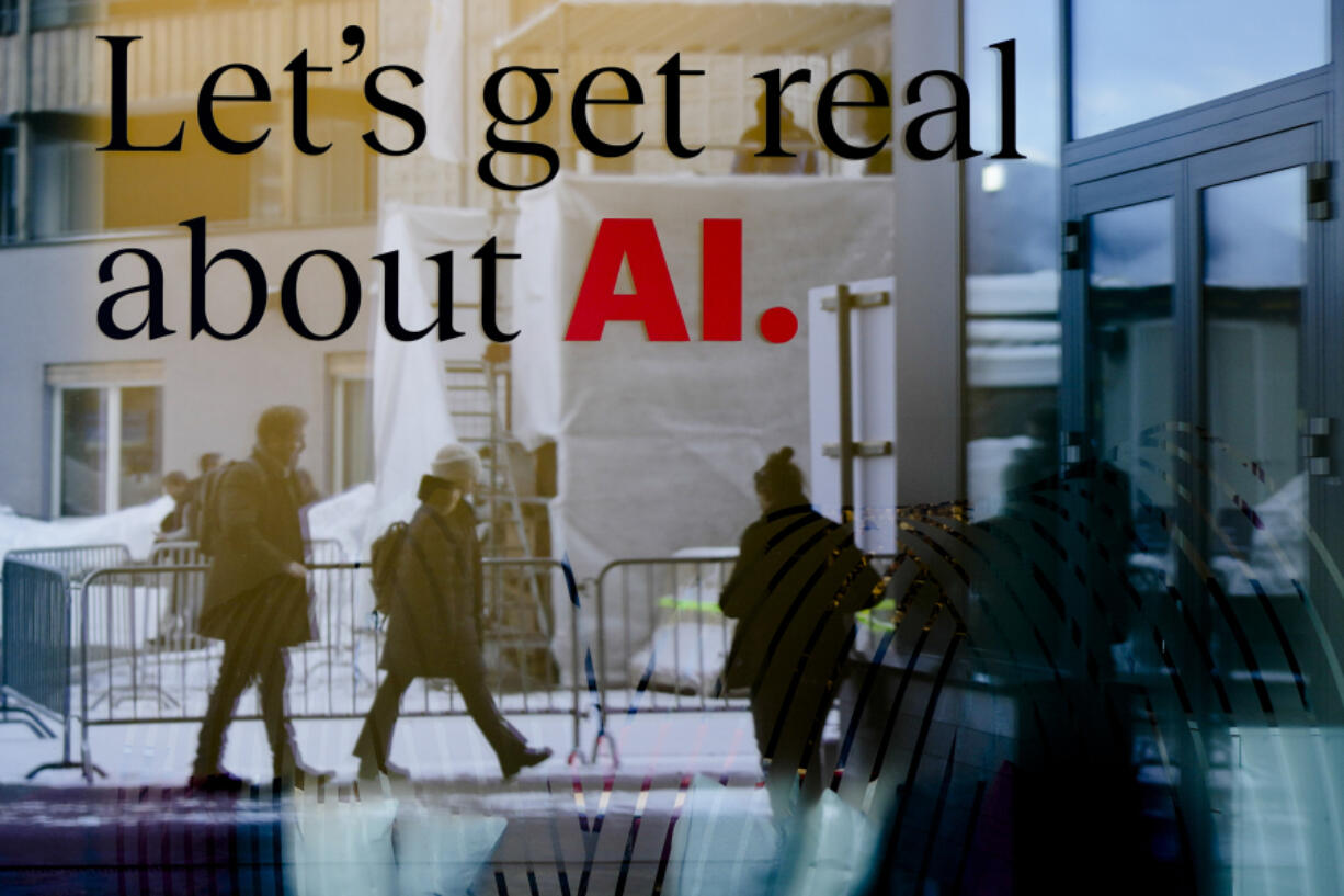 FILE - People are reflected in a window of a hotel at the Davos Promenade in Davos, Switzerland, Jan. 15, 2024. The artificial intelligence startup Perplexity AI has raised tens of millions of dollars from the likes of Jeff Bezos and other prominent tech investors for its mission to rival Google in the business of searching for information.