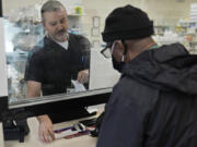 Pharmacist George Tadross, takes care of a customer at MAC Pharmacy, Wednesday, May 29, 2024, in Cleveland. Pharmacists play a role in managing chronic diseases like diabetes and heart-related issues, which Black and Hispanic people are more likely to be diagnosed with.