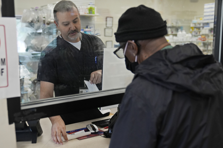 Pharmacist George Tadross, takes care of a customer at MAC Pharmacy, Wednesday, May 29, 2024, in Cleveland. Pharmacists play a role in managing chronic diseases like diabetes and heart-related issues, which Black and Hispanic people are more likely to be diagnosed with.