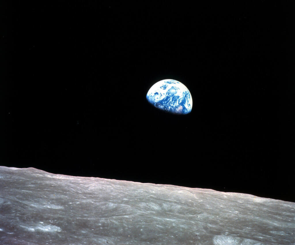 FILE - This Dec. 24, 1968, file photo made available by NASA shows the Earth behind the surface of the moon during the Apollo 8 mission. Retired Maj. Gen. William Anders, the former Apollo 8 astronaut who took the iconic “Earthrise” photo showing the planet as a shadowed blue marble from space in 1968, was killed Friday, June 7, 2024, when the plane he was piloting alone plummeted into the waters off the San Juan Islands in Washington state. He was 90.