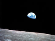 FILE - This Dec. 24, 1968, file photo made available by NASA shows the Earth behind the surface of the moon during the Apollo 8 mission. Retired Maj. Gen. William Anders, the former Apollo 8 astronaut who took the iconic “Earthrise” photo showing the planet as a shadowed blue marble from space in 1968, was killed Friday, June 7, 2024, when the plane he was piloting alone plummeted into the waters off the San Juan Islands in Washington state. He was 90.