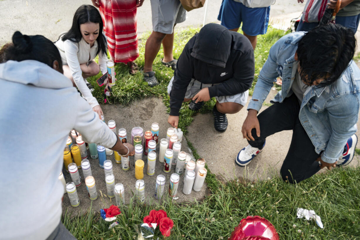 People light candles on the sidewalk during a vigil for 13-year-old Nyah Mway in Utica, N.Y., Saturday, June 29, 2024. On Friday, June 28, Mway was fatally shot by police who&rsquo;d tackled him to the ground after he allegedly pointed what turned out to be a BB gun at them during a foot chase.
